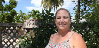 Linda Russin made the airwaves personal - A woman holding a sign posing for the camera - Key West