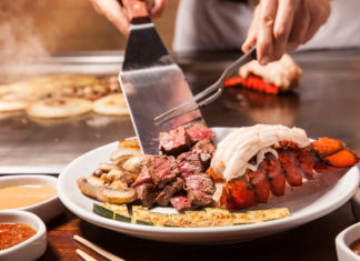 Key West’s Benihana getting a makeover - A woman sitting at a table with a plate of food - Teppanyaki