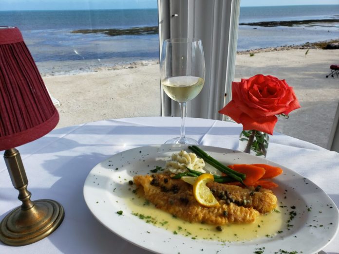 Hideaway Café: the most romantic restaurant in the Keys - A plate of food and a glass of water on a table - Hideaway Café