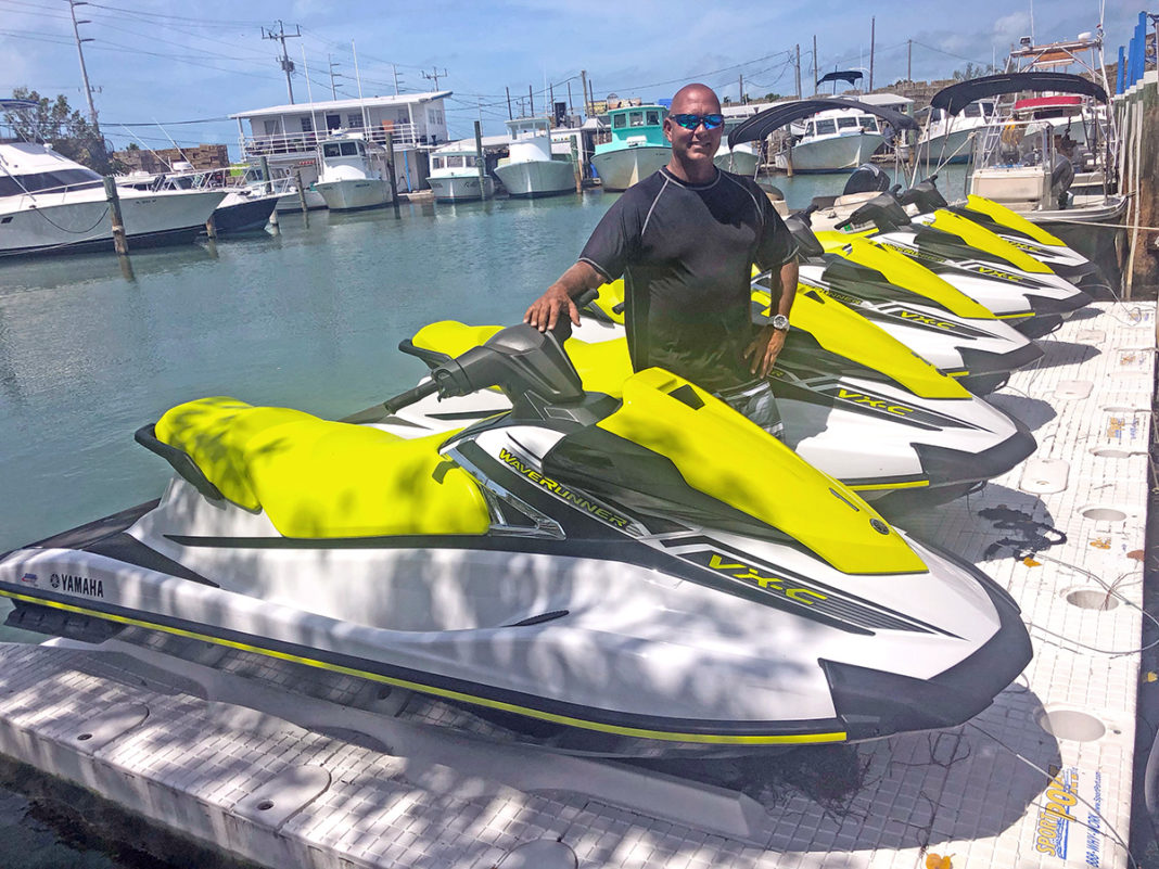 Big Kahuna Watersports offers customizable jet ski tours in Marathon - A man in a yellow boat in the water - Islamorada Boat & Jet Ski Rentals