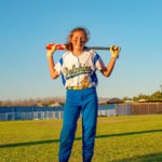 Marathon JV softball - A person holding a kite while standing in the grass - Softball
