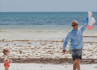 Barefoot Doctor Stan Sack Explores the Uptick in Autism - A person standing on top of a sandy beach - Beach