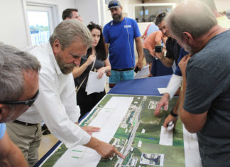Residents give input on Snake Creek bridge - A group of people standing around a table - Islamorada