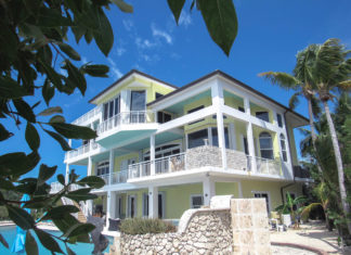 Island Life, Carlos Garcia, Ocean Sothebys - A statue in front of a house - Florida Keys