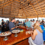 A first look at the new boutique resort on Grassy Key - A group of people standing around a table - Grassy Flats Resort & Beach Club