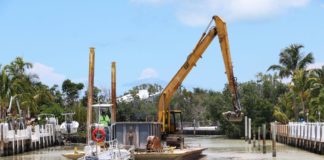 Canal dredging: 2 down, 8 to go - A boat is docked next to a body of water - Canal