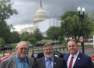 Keys representatives visit D.C. for funding - A man standing in front of a group of people posing for the camera - Luxury vehicle