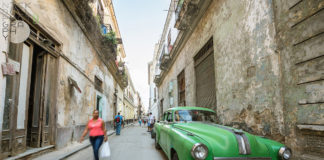 New travel rules make it harder to get to Cuba - A close up of a boy in a green car parked on a sidewalk - Florida Keys