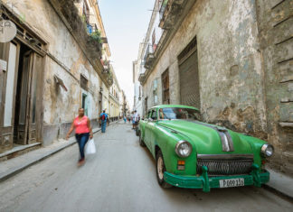 New travel rules make it harder to get to Cuba - A close up of a boy in a green car parked on a sidewalk - Florida Keys