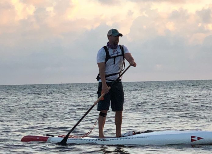 Tavernier man paddling for a cause - A man standing next to a body of water - Florida Keys