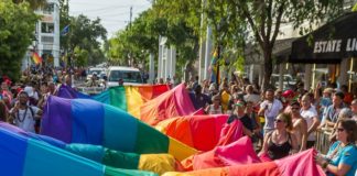 Rainbows in Forecast for Key West - A crowd of people watching a colorful blanket - Key West