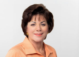 Virginia Panico Announces Retirement – Key West Chamber Head Steps Down in December - A woman wearing a white shirt and smiling at the camera - Florida Keys