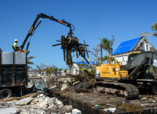 County: 76 more canals to be cleaned in the Keys - A crane next to a pile of dirt - Florida Keys