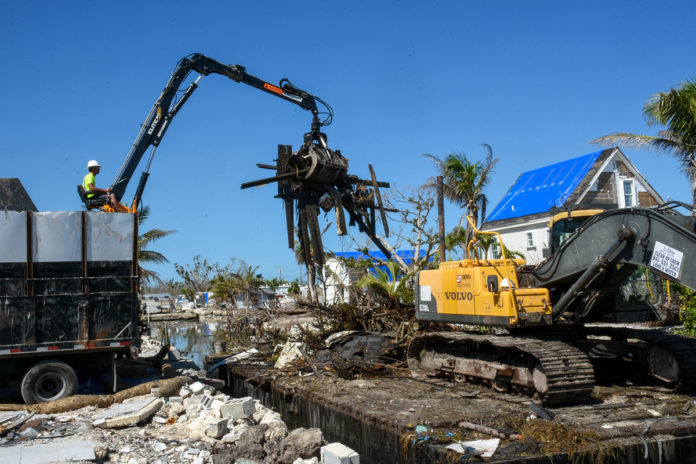 canal cleanup County: 76 more canals to be cleaned in the Keys - A crane next to a pile of dirt - Florida Keys