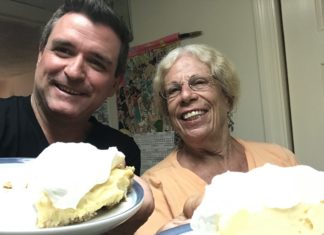 Key Lime Legends – The Cookie Lady - A person is smiling while holding a piece of cake on a plate - Florida Keys