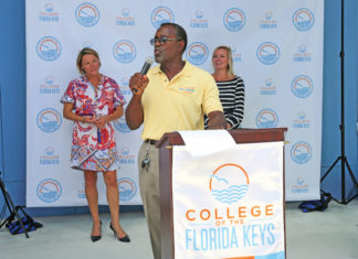 Newly named College of Florida Keys celebrates new day - A group of people holding a sign posing for the camera - Florida Keys