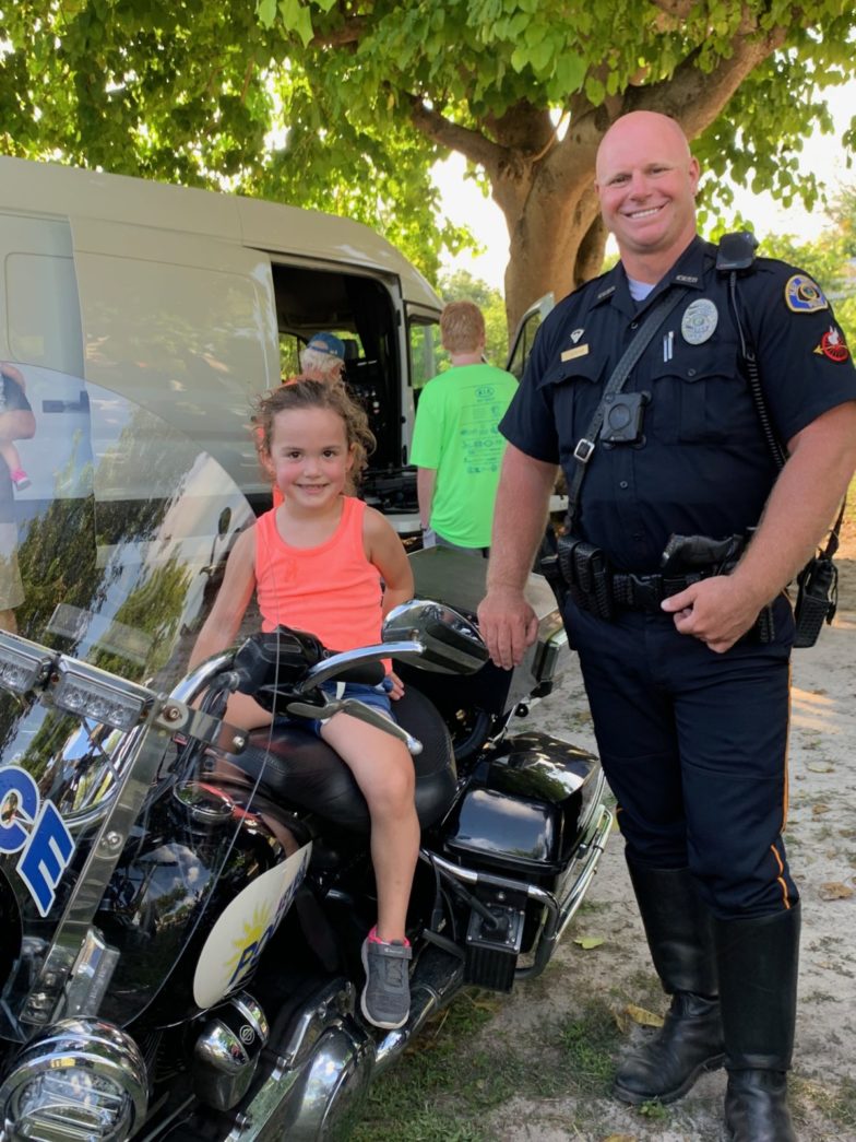 National Night Out – Key West Celebrates and Socializes with First Responders - A couple of people standing around a motorcycle - Car
