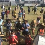 Putting the Band Back Together – KWHS Marching Band prepares for the field - A group of people standing in front of a crowd - Marching band