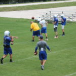 NEW ATHLETIC COMPLEX – MHS teams already at practice - A group of people playing football on a field - American football
