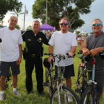 COMMUNITY PARTNERS – Family, food and fun with first responders - A group of people riding on the back of a bicycle - Cyclo-cross