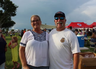 COMMUNITY PARTNERS – Family, food and fun with first responders - A couple of people that are standing in the grass - Weekly Newspapers
