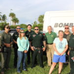 COMMUNITY PARTNERS – Family, food and fun with first responders - A group of people posing for a photo - Car