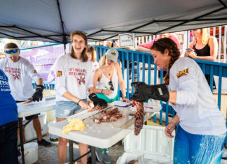 Lionfish Derby at Postcard Inn set for Sept. 13-15 - A group of people standing around a table - Weekly Newspapers