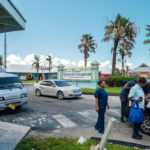 Keys Weekly photographer documents Bahamas plight - A group of people standing in a parking lot - Luxury vehicle