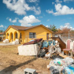 Keys Weekly photographer documents Bahamas plight - A person sitting in front of a house - Florida Keys
