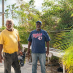 Keys Weekly photographer documents Bahamas plight - A man standing next to a palm tree - Florida Keys