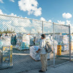 Keys Weekly photographer documents Bahamas plight - A man standing next to a fence - Florida Keys