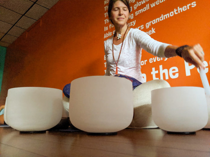 A woman sitting on floor doing yoga