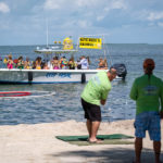 GOLFIN’ CONCH STYLE – Funds raised for school, community programs - A group of people standing on top of a sandy beach - Beach
