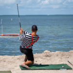 GOLFIN’ CONCH STYLE – Funds raised for school, community programs - A man standing next to a body of water - Shore