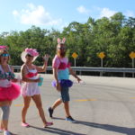 PINK ARMY – Inaugural bra walk in Key Largo sees large support - A little girl walking down the street - Long-distance running