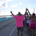 PINK ARMY – Inaugural bra walk in Key Largo sees large support - A person standing next to a body of water - Car