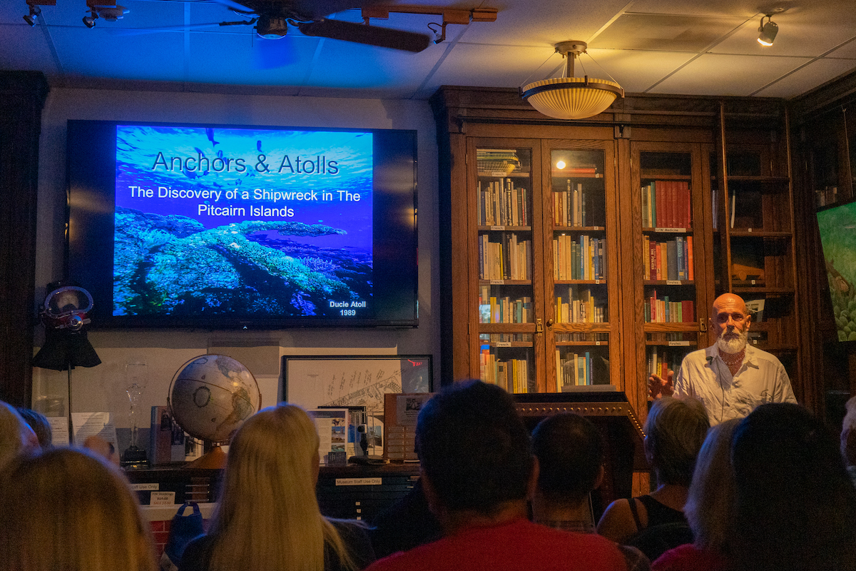 SHIPWRECKS AND SAILORS – Adventurous tale captivates crowd - A group of people standing in front of a television - Convention