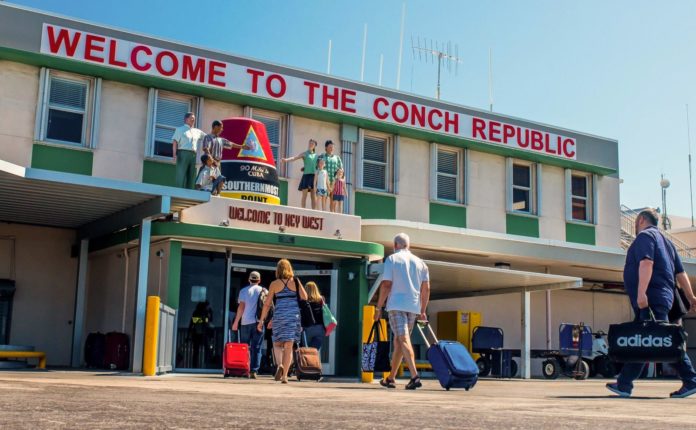 Direct Flights from Boston Logan Airport to Key West - A group of people standing in front of a store - Key West International Airport