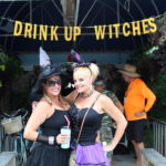 BROOMSTICK PARKING ONLY – Annual Witches’ Ride raises funds for cancer research - A person standing in front of a fence - Vacation
