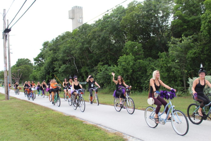 BROOMSTICK PARKING ONLY – Annual Witches’ Ride raises funds for cancer research - A group of people riding on the back of a bicycle - Road bicycle racing