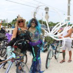 BROOMSTICK PARKING ONLY – Annual Witches’ Ride raises funds for cancer research - A group of people standing next to a bicycle - Road bicycle