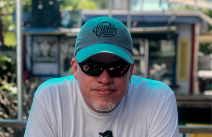 Caffeine Carl: Key West’s own music man - A man wearing a hat - Sunglasses
