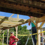 Guess what? Habitat is still helping homeowners recover from Irma - A group of people standing on top of a wooden bridge - Roof