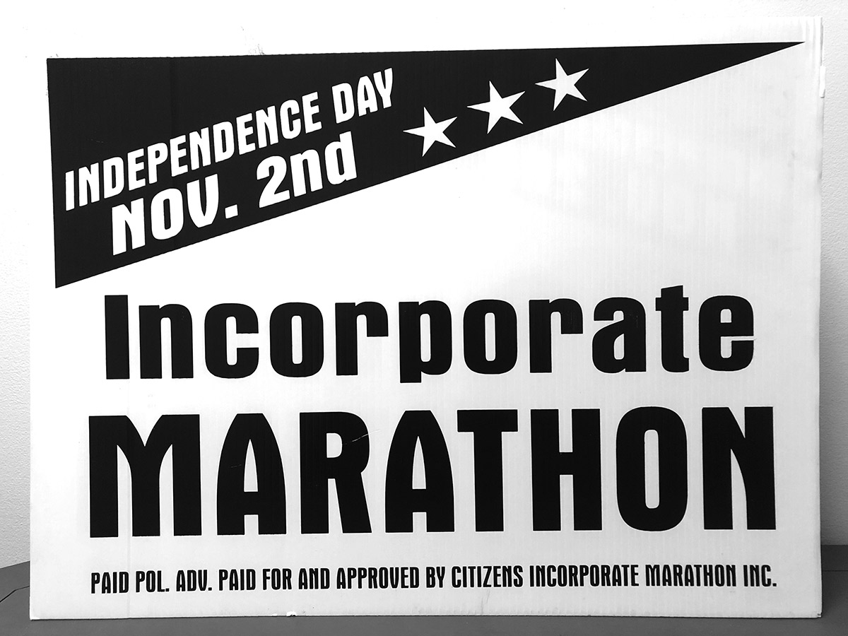 Celebrating 20 years: Marathon’s roots traced back to property rights - A close up of text on a black background - Banner