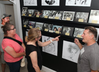 Tennessee Williams Museum opens new exhibit – Rare photos show playwright’s personality - A group of people standing in a room - Art exhibition