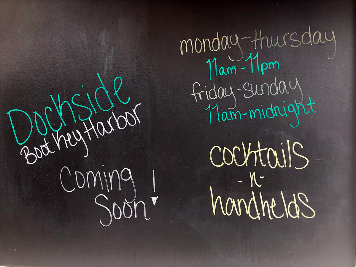 Dockside reopens this week - A blackboard sign on a wall - Calligraphy