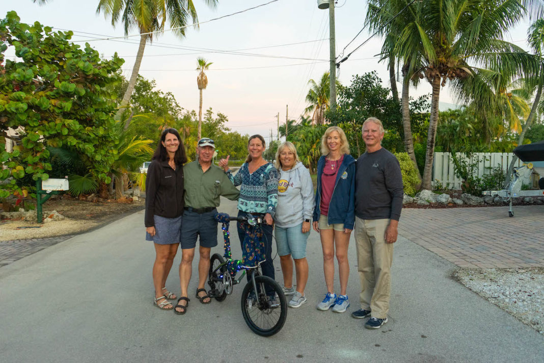 Flood-free finally for Key Largo community - A group of people riding on the back of a bicycle - Road bicycle