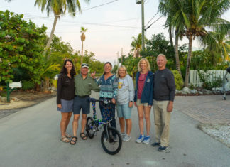 Flood-free finally for Key Largo community - A group of people riding on the back of a bicycle - Road bicycle