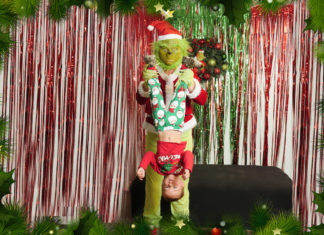 WINNER – Keys Holiday Photo Contest - A person standing next to a christmas tree posing for the camera - Christmas tree