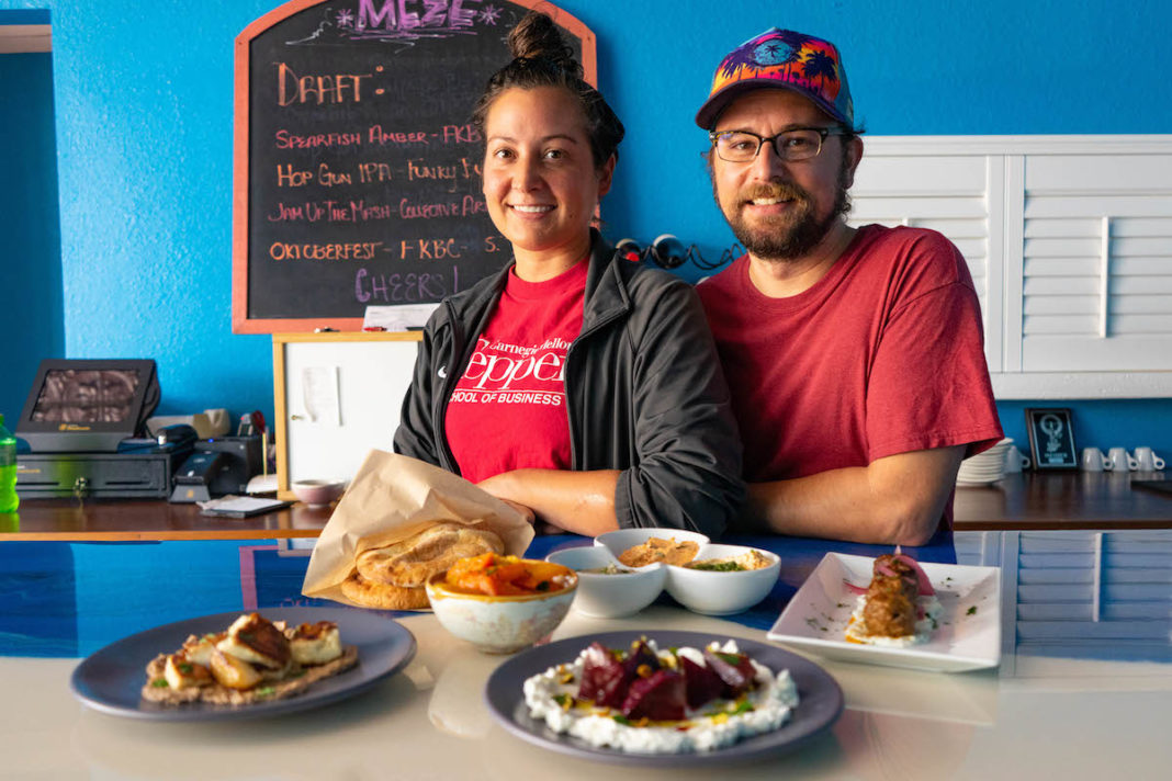 CREATIVE CUISINE – Enjoy spreads, pita bread, skewers at Meze Morada - A person sitting at a table with a plate of food - Breakfast